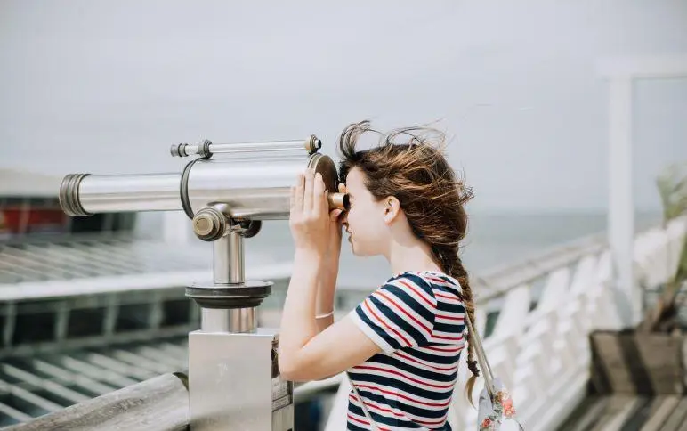 a woman looking at a railing